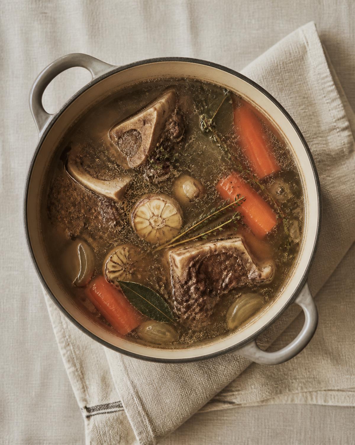 Stockpot of bones, herbs and vegetables slowly simmering